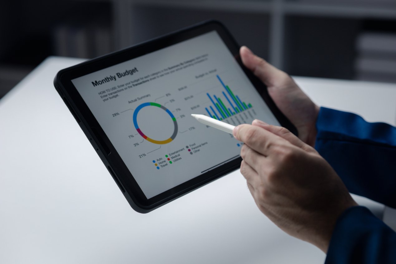 person looking at data on tablet businessman owner cx6lmmd (1)